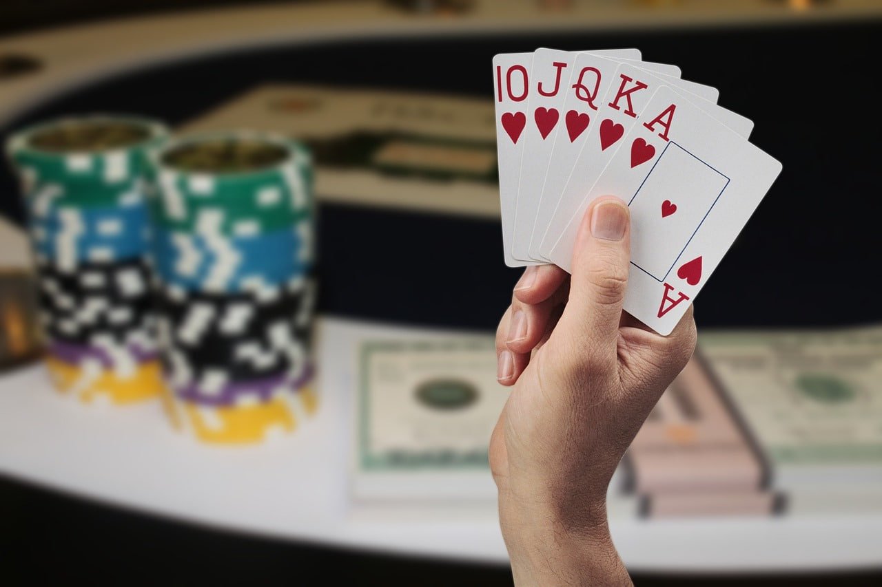 Live casino table with real dealer cards and chips on screen